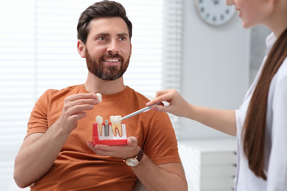 Person being shown dental implants